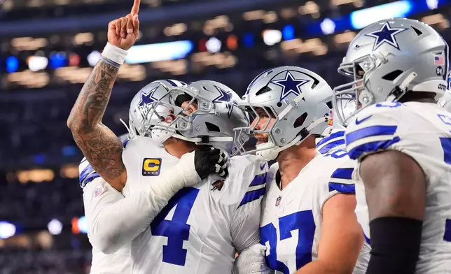 Dallas Cowboys quarterback Dak Prescott (4) celebrates his rushing touchdown during the second half of an NFL football game against the Philadelphia Eagles, Sunday, Nov. 23, 2025, in Arlington, Texas. (AP Photo/Tony Gutierrez)