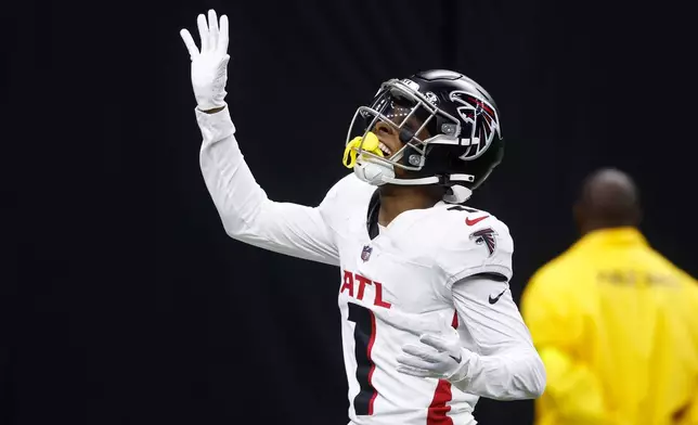 Atlanta Falcons wide receiver Darnell Mooney celebrates a touchdown reception against the New Orleans Saints in the second half of an NFL football game, Sunday, Nov. 23, 2025, in New Orleans. (AP Photo/Butch Dill)