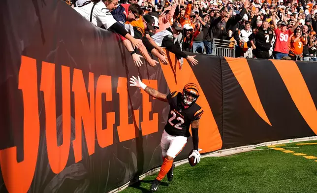 Cincinnati Bengals safety Geno Stone celebrates after returning an interception for a touchdown during the first half of an NFL football game against the New England Patriots, Sunday, Nov. 23, 2025, in Cincinnati. (AP Photo/Carolyn Kaster)