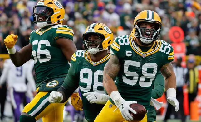 Green Bay Packers linebacker Isaiah McDuffie (58) celebrates after intercepting a pass during the second half of an NFL football game against the Minnesota Vikings Sunday, Nov. 23, 2025, in Green Bay, Wis. (AP Photo/Mike Roemer)