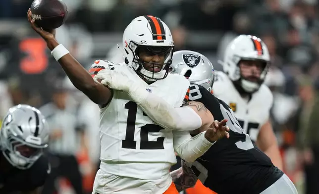 Las Vegas Raiders defensive end Maxx Crosby (98) pressures Cleveland Browns quarterback Shedeur Sanders (12) during the second half of an NFL football game Sunday, Nov. 23, 2025, in Las Vegas. (AP Photo/Candice Ward)