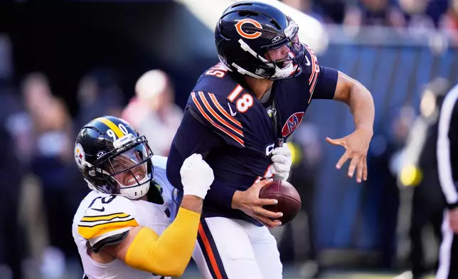 Pittsburgh Steelers linebacker T.J. Watt (90) sacks Chicago Bears quarterback Caleb Williams, forcing a fumble that the Steelers Nick Herbig recovered in the end zone for a touchdown during the first half of an NFL football game Sunday, Nov. 23, 2025, in Chicago. (AP Photo/Erin Hooley)