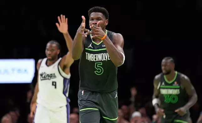 Minnesota Timberwolves guard Anthony Edwards (5) reacts after making a 3-point basket during the second half of an NBA Cup basketball game against the Sacramento Kings, Friday, Nov. 14, 2025, in Minneapolis. (AP Photo/Abbie Parr)