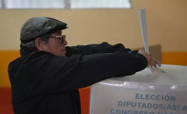 A voter casts his ballot during general elections in Tegucigalpa, Honduras, Sunday, Nov. 30, 2025. (AP Photo/Moises Castillo)