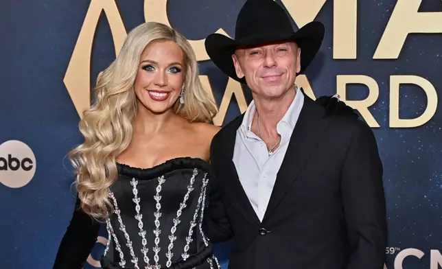 Megan Moroney, left, and Kenny Chesney arrive at the 59th Annual Country Music Association Awards on Wednesday, Nov. 19, 2025, at Bridgestone Arena in Nashville, Tenn. (Photo by Evan Agostini/Invision/AP)