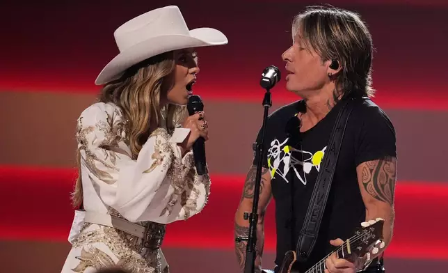 Host Lainey Wilson, left, and Keith Urban perform during the 59th Annual Country Music Association Awards on Wednesday, Nov. 19, 2025, at Bridgestone Arena in Nashville, Tenn. (AP Photo/George Walker IV)
