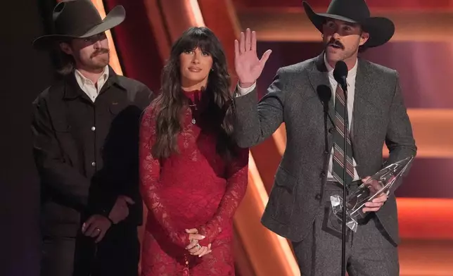Will Bundy, from left, Ella Langley and Riley Green receive the award for single of the year for "you look like you love me" during the 59th Annual Country Music Association Awards on Wednesday, Nov. 19, 2025, at Bridgestone Arena in Nashville, Tenn. (AP Photo/George Walker IV)