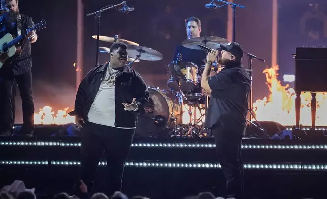 BigXthaPlug, left, and Luke Combs perform "Pray Hard during the 59th Annual Country Music Association Awards on Wednesday, Nov. 19, 2025, at Bridgestone Arena in Nashville, Tenn. (AP Photo/George Walker IV)