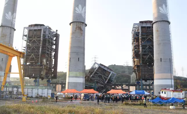 Rescue team work near a 60-meter (196-foot) tower which collapsed during demolition work at a decommissioned thermal power plant in Ulsan, South Korea, Thursday, Nov. 6, 2025. (Bae Byung-soo/Newsis via AP)