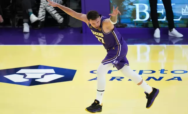 Los Angeles Lakers guard Luka Doncic celebrates his three-point basket during the first half of an NBA Cup basketball game against the Los Angeles Clippers Tuesday, Nov. 25, 2025, in Los Angeles. (AP Photo/Jae C. Hong)