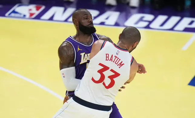 Los Angeles Clippers forward Nicolas Batum (33) is fouled by Los Angeles Lakers forward LeBron James during the first half of an NBA Cup basketball game Tuesday, Nov. 25, 2025, in Los Angeles. (AP Photo/Jae C. Hong)