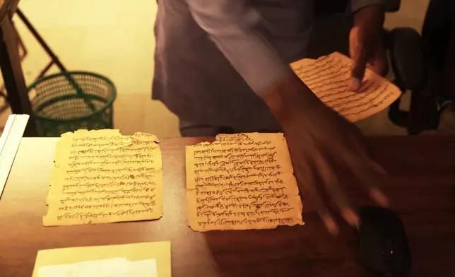 Manuscript pages are being scan at the Ahmed Baba Institute of Higher Islamic Studies and Research in Timbuktu, Mali, Sept. 4, 2025. (AP Photo/Baba Ahmed)