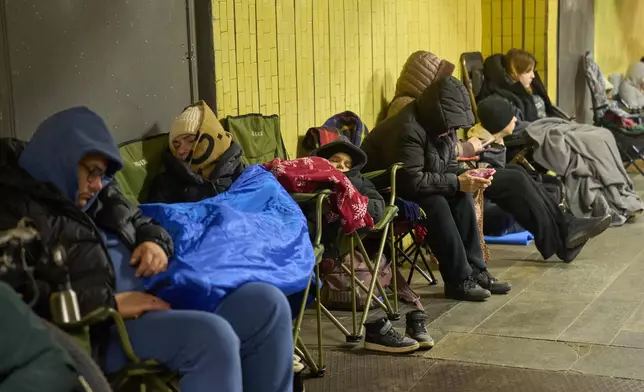 People hide in an underground pedestrian crossing during Russia's night missile and drone attack in Kyiv, Ukraine, Saturday, Nov. 29, 2025. (AP Photo/Efrem Lukatsky)