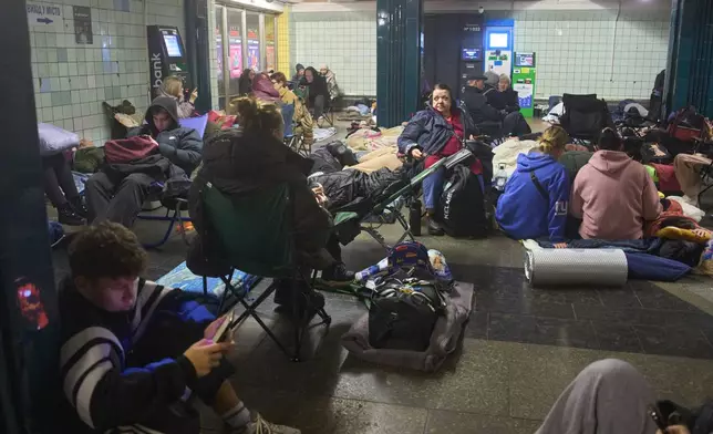 People hide in a subway station during Russia's night missile and drone attack in Kyiv, Ukraine, Saturday, Nov. 29, 2025. (AP Photo/Efrem Lukatsky)