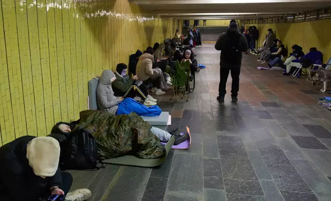 People hide in an underground pedestrian crossing during Russia's night missile and drone attack in Kyiv, Ukraine, Saturday, Nov. 29, 2025. (AP Photo/Efrem Lukatsky)