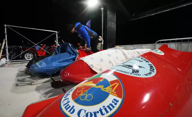 A forerunner practices on his bobsled during a training session ahead of a three-day skeleton and bobsled World Cup stage and Olympic test event in Cortina D'Ampezzo, Italy, Wednesday, Nov. 19, 2025. (AP Photo/Andrew Medichini)