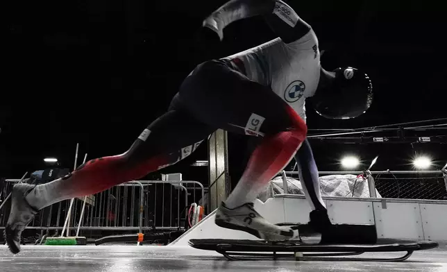 South Korea's Jung Seunggi takes the start at a training session ahead of a three day skeleton and bobsled World Cup stage and Olympic test event in Cortina D'Ampezzo, Italy, Wednesday, Nov. 19, 2025. (AP Photo/Andrew Medichini)