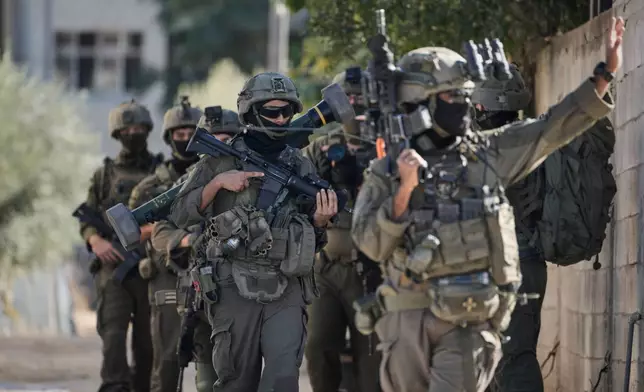 Israeli soldiers are seen during an army raid in the West Bank town of Tubas, Wednesday, Nov. 26, 2025. (AP Photo/Majdi Mohammed)