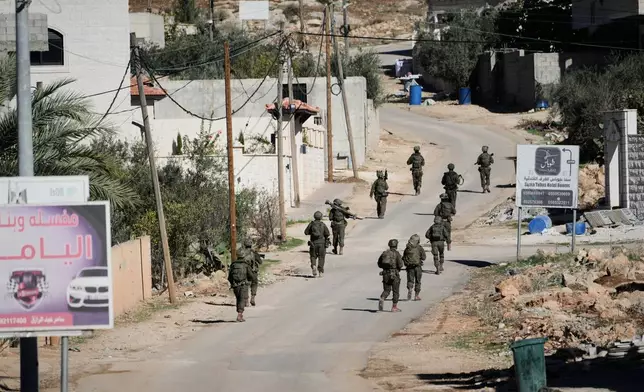 Israeli soldiers are seen during an army raid in the West Bank town of Tubas, Wednesday, Nov. 26, 2025. (AP Photo/Majdi Mohammed)