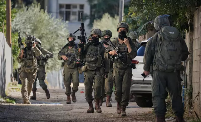 Israeli soldiers are seen during an army raid in the West Bank town of Tubas, Wednesday, Nov. 26, 2025. (AP Photo/Majdi Mohammed)