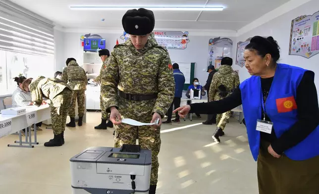A Kyrgyz Army soldier casts his ballot during the parliamentary elections at a polling station in Tash-Dobo, 19 km (11 miles) south of Bishkek, Kyrgyzstan, Sunday, Nov. 30, 2025. (AP Photo/Vladimir Voronin)