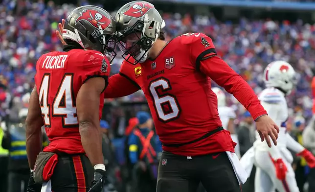 Tampa Bay Buccaneers running back Sean Tucker (44) celebrates with quarterback Baker Mayfield (6) after scoring a touchdown against the Buffalo Bills during the second half of an NFL football game, Sunday, Nov. 16, 2025, in Orchard Park, N.Y. (AP Photo/Jeffrey T. Barnes)