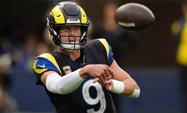 Los Angeles Rams quarterback Matthew Stafford passes during the first half of an NFL football game against the Seattle Seahawks, Sunday, Nov. 16, 2025, in Inglewood, Calif. (AP Photo/Gregory Bull)