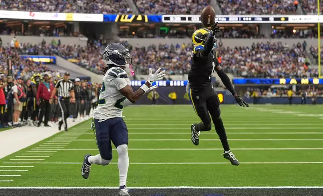 Los Angeles Rams cornerback Emmanuel Forbes, right, breaks up a pass intended for Seattle Seahawks wide receiver Rashid Shaheed during the second half of an NFL football game Sunday, Nov. 16, 2025, in Inglewood, Calif. (AP Photo/Gregory Bull)
