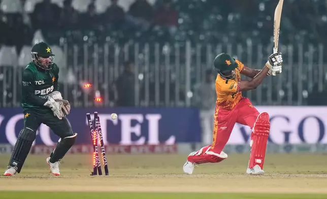 Zimbabwe's Tashinga Musekiwa, right, is bowled out by Pakistan's Abrar Ahmed during the tri-series T20 cricket match between Pakistan and Zimbabwe, in Rawalpindi, Pakistan, Tuesday, Nov. 18, 2025. (AP Photo/Anjum Naveed)