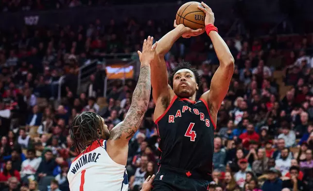 Toronto Raptors' Scottie Barnes (4) shoots over Washington Wizards' Cam Whitmore (1) during first half NBA basketball action in Toronto, Friday, Nov. 21, 2025. (Sammy Kogan/The Canadian Press via AP)