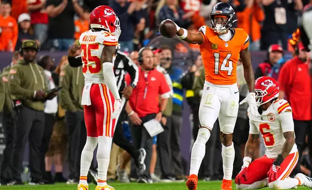 Denver Broncos wide receiver Courtland Sutton (14) celebrates making a catch for a first down as Kansas City Chiefs cornerback Jaylen Watson (35) and safety Bryan Cook (6) watch during the second half an NFL football game Sunday, Nov. 16, 2025, in Denver. (AP Photo/Jack Dempsey)