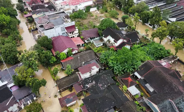 This aerial shot taken using a drone shows a flooded neighborhood in Medan, North Sumatra, Indonesia, Friday, Nov. 28, 2025. (AP Photo/Binsar Bakkara)