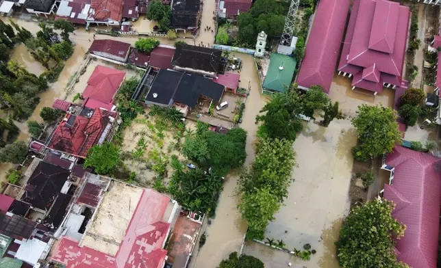This aerial shot taken using a drone shows a flooded neighborhood in Medan, North Sumatra, Indonesia, Friday, Nov. 28, 2025. (AP Photo/Binsar Bakkara)
