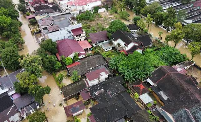 This aerial shot taken using a drone shows a flooded neighborhood in Medan, North Sumatra, Indonesia, Friday, Nov. 28, 2025. (AP Photo/Binsar Bakkara)