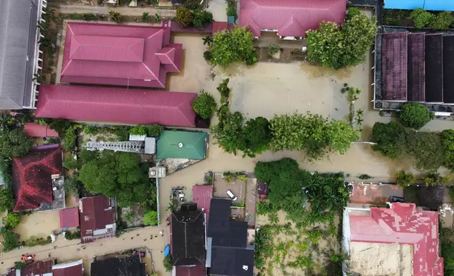 This aerial shot taken using a drone shows a flooded neighborhood in Medan, North Sumatra, Indonesia, Friday, Nov. 28, 2025. (AP Photo/Binsar Bakkara)