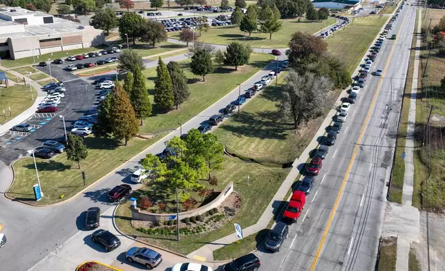Cars line up for a pop-up food distribution event to provide extra support for Tulsa families affected by the recent lapse in SNAP benefits, at Food on the Move in Tulsa, Okla., on Thursday, Nov. 6, 2025. (Mike Simons/Tulsa World via AP)