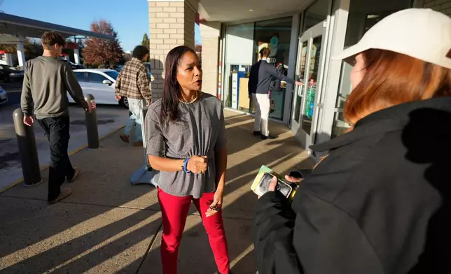 Virginia House of Delegates, Del.-elect, Nicole Cole, center, speaks with constituent Kaitlyn Sapp, at a convince store Thursday, Nov. 13, 2025, in Fredericksburg, Va. (Steve Helber)