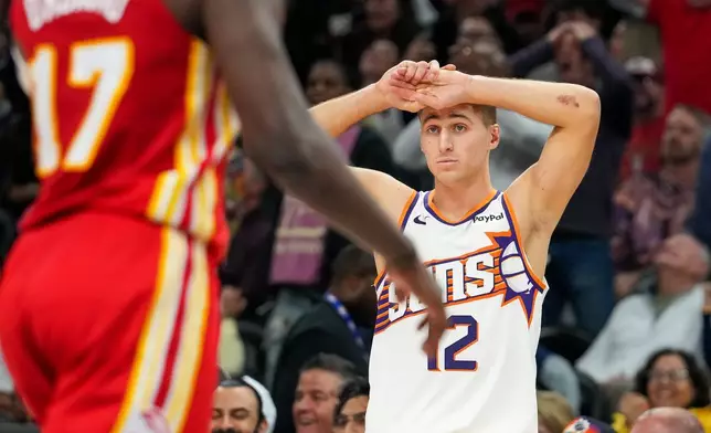 Phoenix Suns guard Collin Gillespie (12) reacts after losing to the Atlanta Hawks at the end of the second half of an NBA basketball game in Phoenix, Sunday, Nov. 16, 2025. (AP Photo/Darryl Webb)