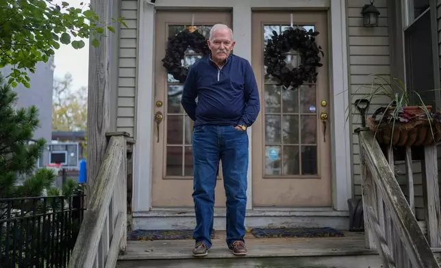 Skip Yates, who witnessed federal immigration agents deploy tear gas on his street in Lakeview in October, stands in front of his home, Wednesday, Nov. 19, 2025, in Chicago. (AP Photo/Erin Hooley)