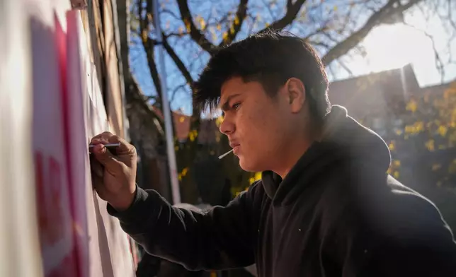 Uriel Villegas, who recorded cell phone video of the incident involving his older brother and as agents arrested two others in October, works at the construction site where his older brother was taken last month by federal immigration agents, Tuesday, Nov. 18, 2025, in Chicago. (AP Photo/Erin Hooley)