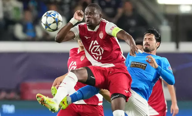 Monaco's Denis Zakaria, centre, challenges for the ball with Pafos' Pepe during the Champions League opening phase soccer match between Pafos FC and AS Monaco in Limassol, Cyprus, Wednesday, Nov. 26, 2025. (AP Photo/Petros Karadjias)
