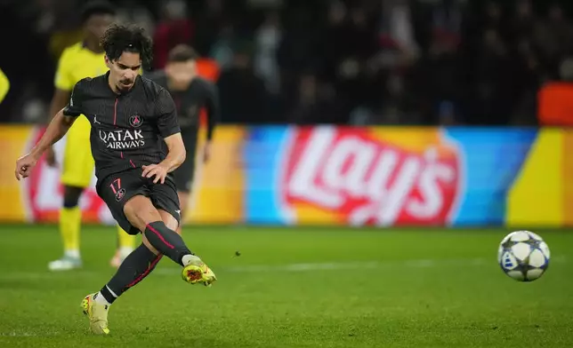 PSG's Vitinha scores on a penalty his side's fifth goal during a Champions League opening phase soccer match between Paris Saint Germain and Tottenham, in Paris, Wednesday, Nov.26, 2025. (AP Photo/Christophe Ena)