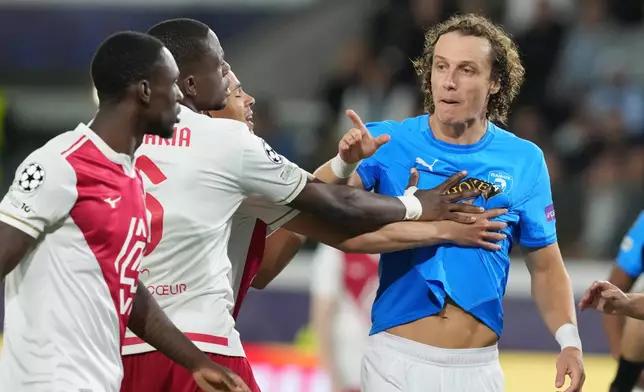 Monaco's Denis Zakaria, second left, argues with Pafos' David Luiz, right, during the Champions League opening phase soccer match between Pafos FC and AS Monaco in Limassol, Cyprus, Wednesday, Nov. 26, 2025. (AP Photo/Petros Karadjias)