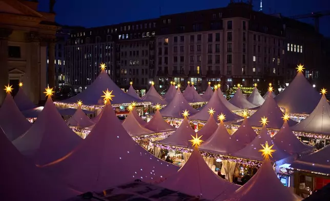 Lights illuminate the Christmas market at the Gendarmen Markt square in Berlin, Germany, Monday, Nov. 24, 2025. (AP Photo/Markus Schreiber)