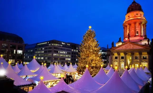Lights illuminate the Christmas market at the Gendarmen Markt square in Berlin, Germany, Monday, Nov. 24, 2025. (AP Photo/Markus Schreiber)