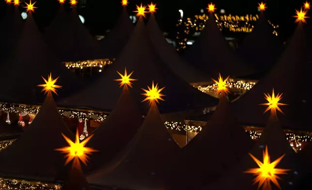 Lights illuminate the Christmas market at the Gendarmen Markt square in Berlin, Germany, Monday, Nov. 24, 2025. (AP Photo/Markus Schreiber)