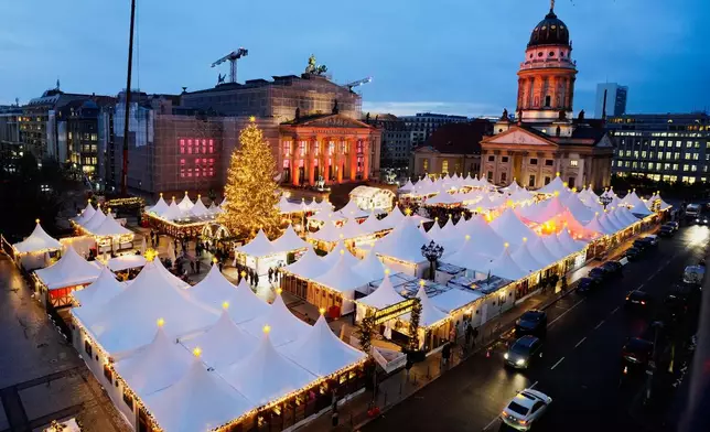 Lights illuminate the Christmas market at the Gendarmen Markt square in Berlin, Germany, Monday, Nov. 24, 2025. (AP Photo/Markus Schreiber)