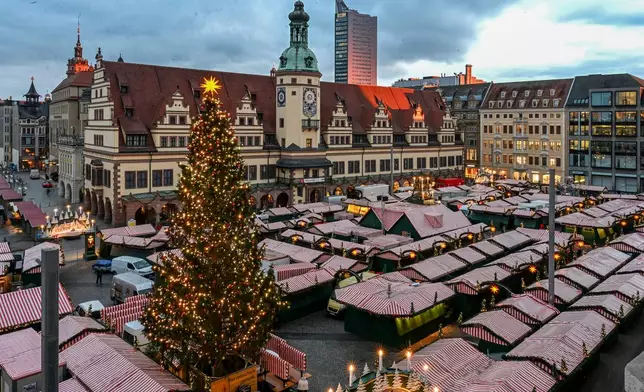 The Christmas tree at Leipzig's Christmas market is illuminated during a lighting rehearsal, in Leipzig, Germany, Thursday, Nov. 20, 2025. (Jennifer Brückner/dpa via AP)