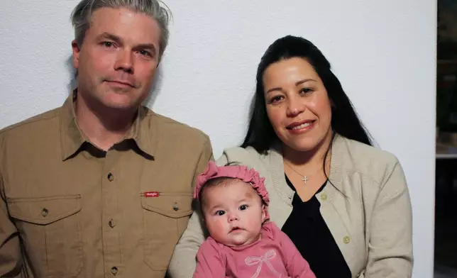 Stephen and Yurany Dexter hold their 4-month-old daughter, who was recently hospitalized for botulism, at their home in Flagstaff, Ariz. on Wednesday, Nov. 12, 2025. (AP Photo/Cheyanne Mumphrey)