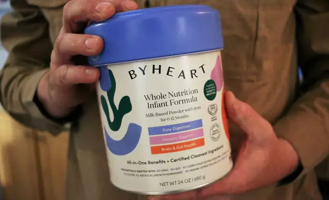Stephen Dexter holds a container of ByHeart baby formula, which was recently recalled by ByHeart, in Flagstaff, Ariz., on Wednesday, Nov. 12, 2025. (AP Photo/Cheyanne Mumphrey)